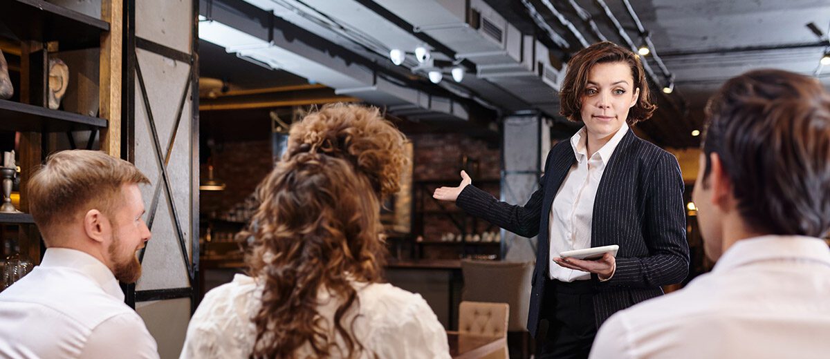 woman talking to restaurant staff