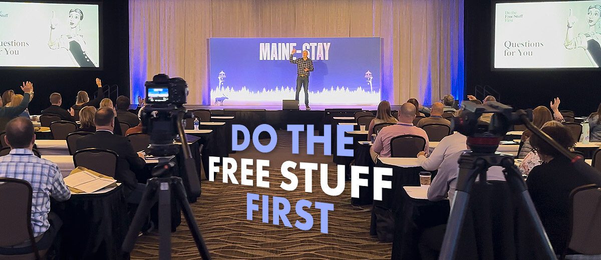 do the free stuff first graphic, man on stage, words