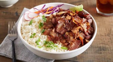 cooked shaved pork belly on a rice bowl