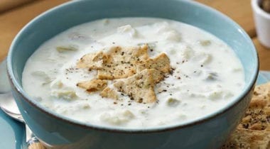 haddock chowder in blue bowl with garnish