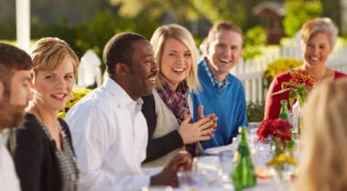 people sitting at a table laughing