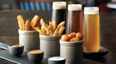 fried appetizers with glasses of beer