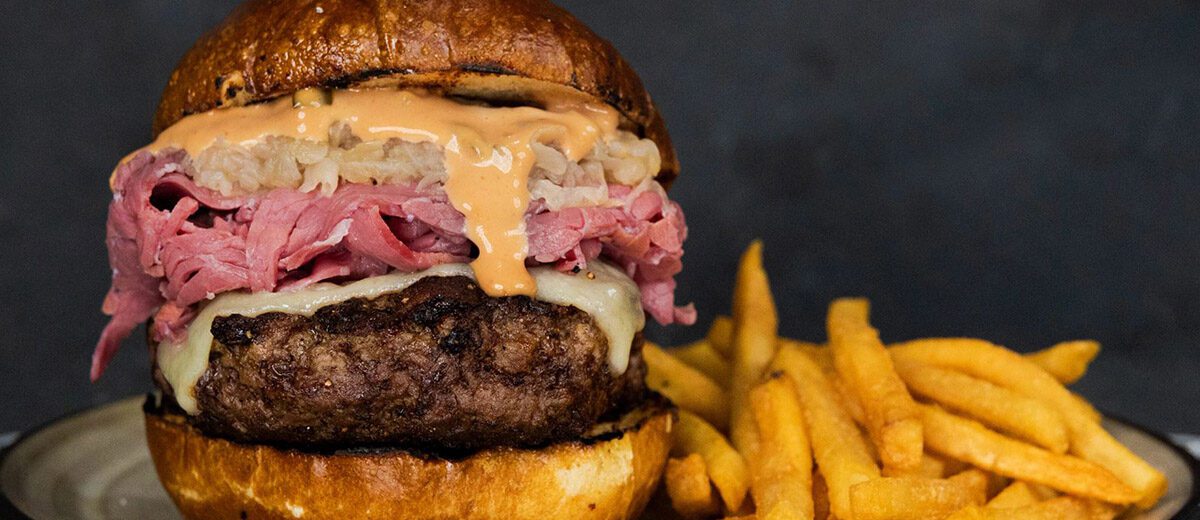 burger topped with Reuben ingredients