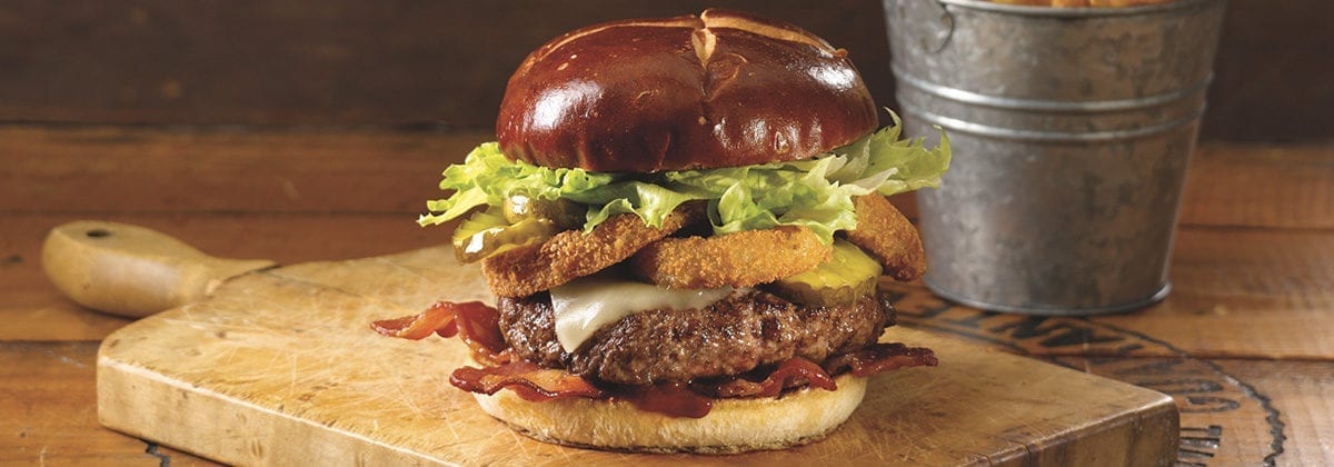 rodeo burger with onion rings on it