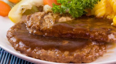 salisbury steak with brown gravy and vegetables