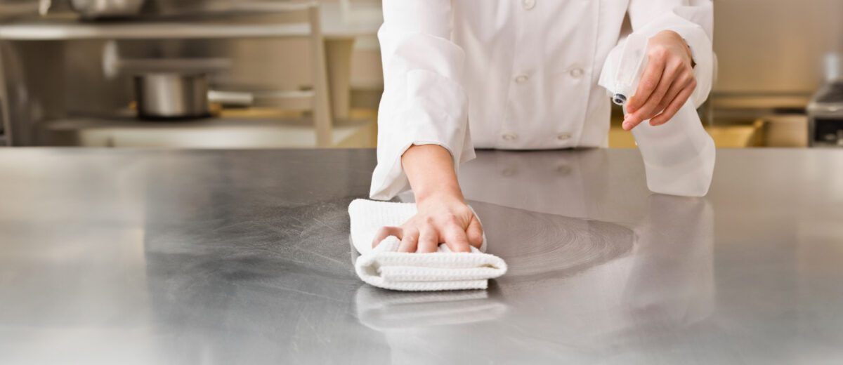 chef cleans stainless steel