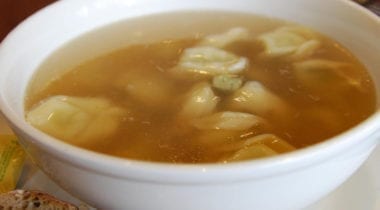 chicken broth in a white bowl